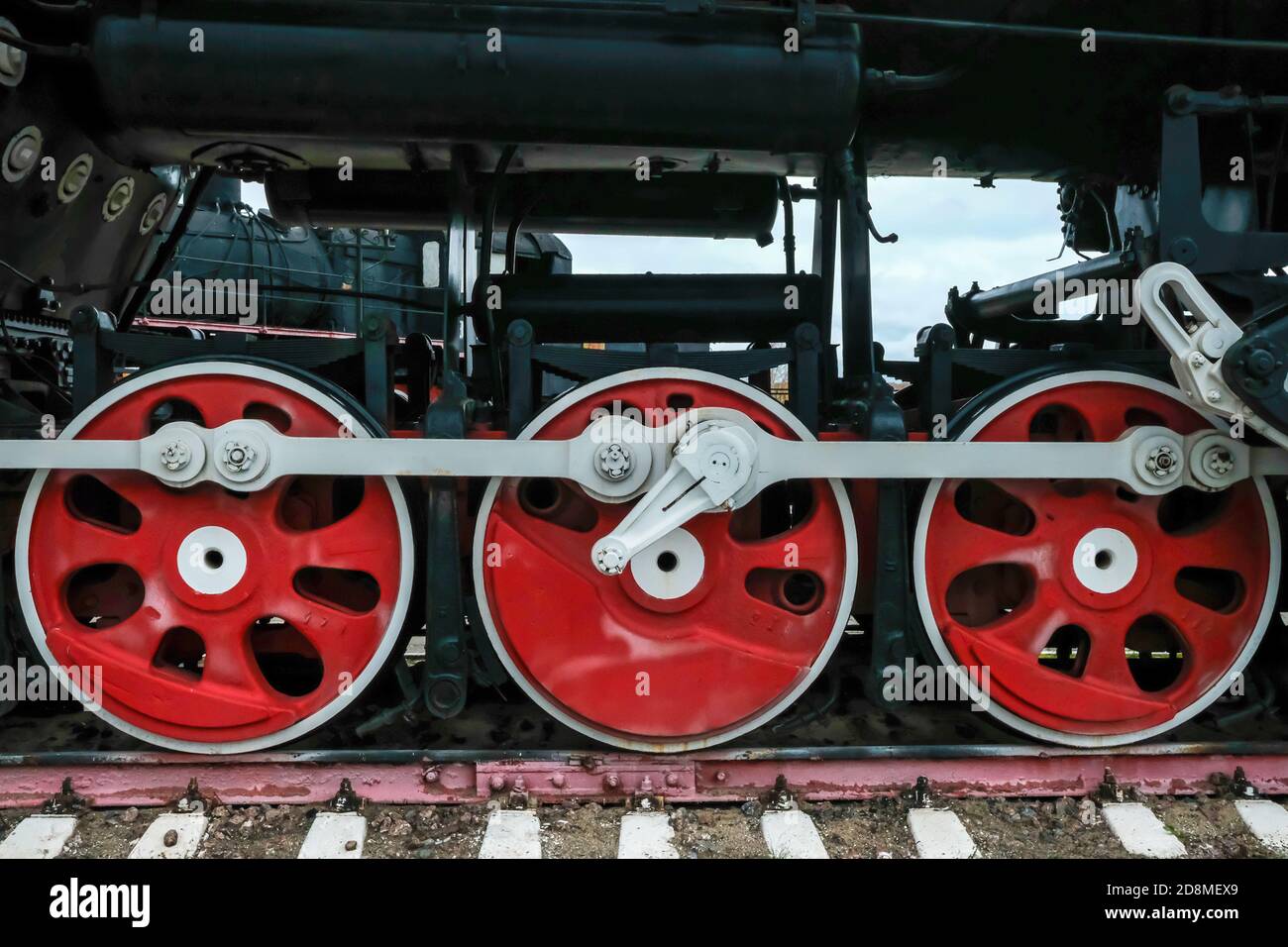 Old Russian train has been made on 1900. Old Russian locomotive. Steam locomotive with red wheels. Retro locomotive on rails. Stock Photo