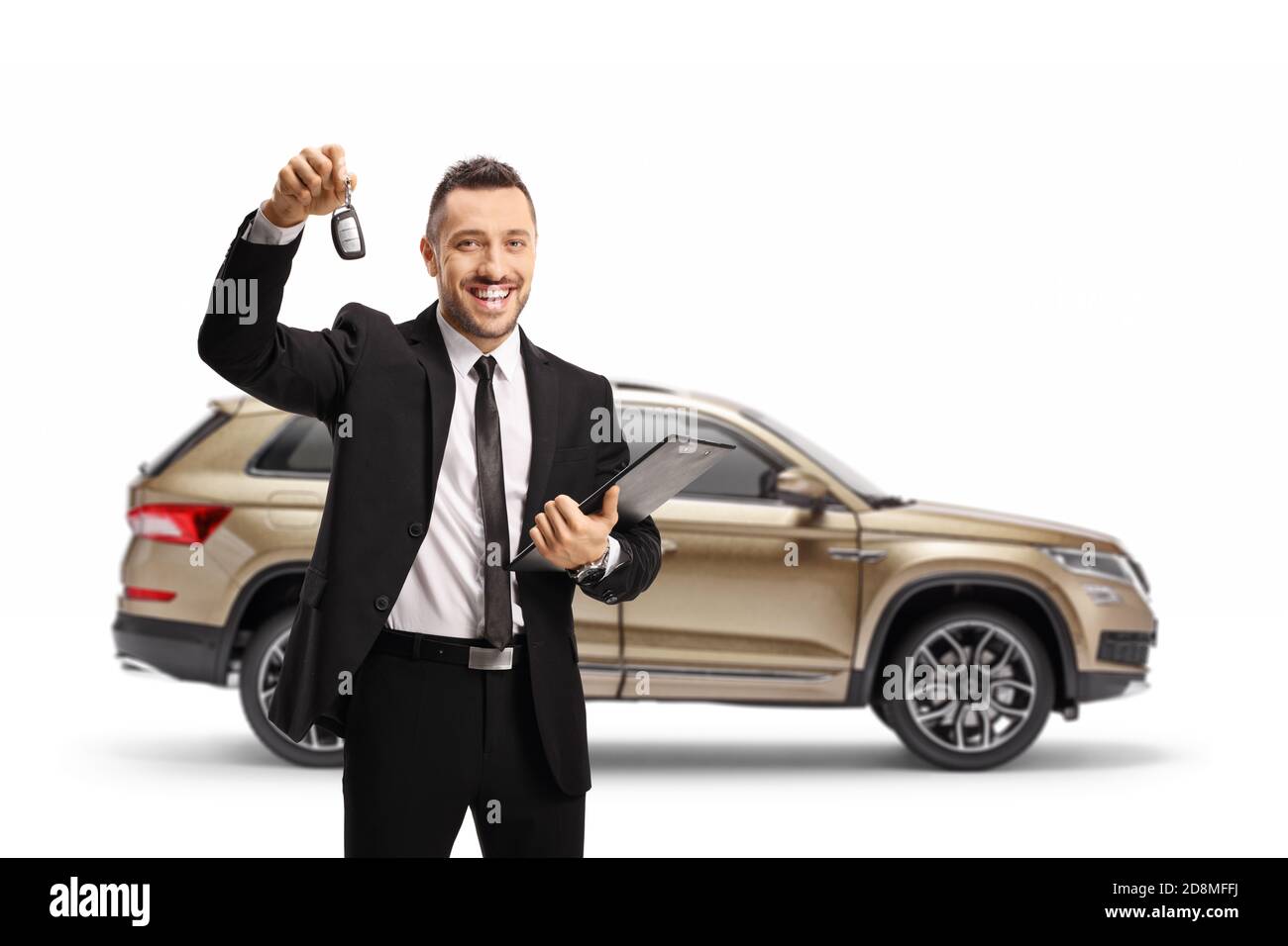 Car salesman showing SUV keys and holding a clipboard isolated on white background Stock Photo