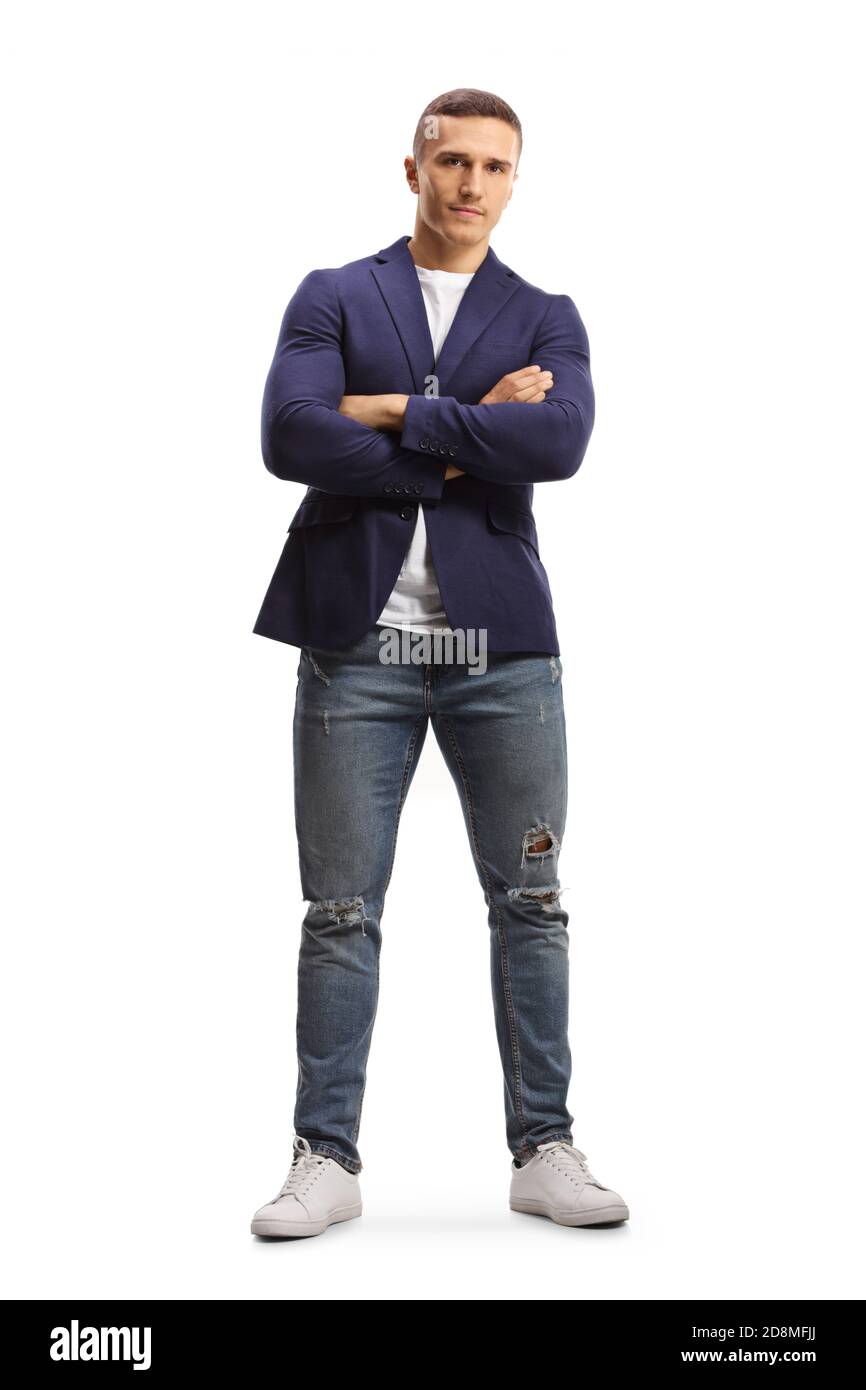 Full length profile shot of a fit young man in ripped jeans and suit posing with crossed arms isolated on white background Stock Photo