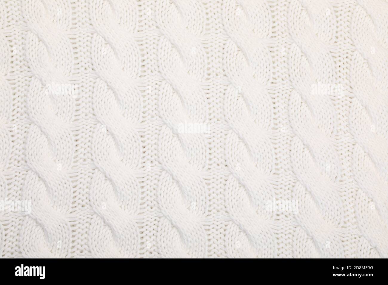 Real white knitted fabric with cable pattern textured background Stock Photo