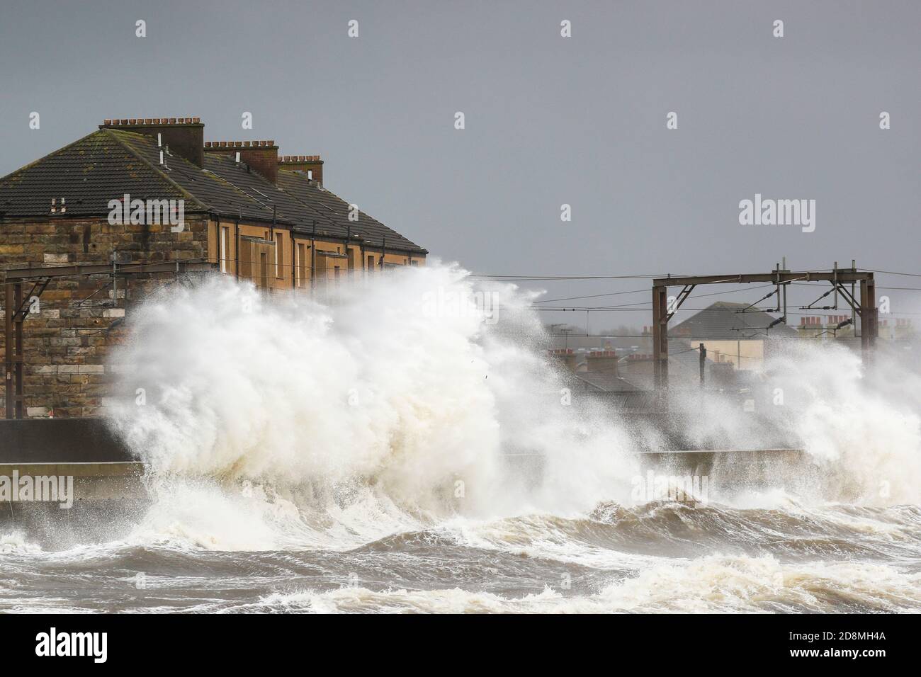 Saltcoats, UK. 31st Oct, 2020. The west coast of Scotland at Saltcoats on the Firth of Clyde was battered by high winds and rain as Hurricane Oscar barrelled across the Atlantic bringing stormy conditions and possible flooding. The waves were so high and dangerous that Scotrail had to withdraw all electric trains on the Kilwinning to Ardrossan line and try to maintain a service using diesel engines. Credit; Credit: Findlay/Alamy Live News Stock Photo