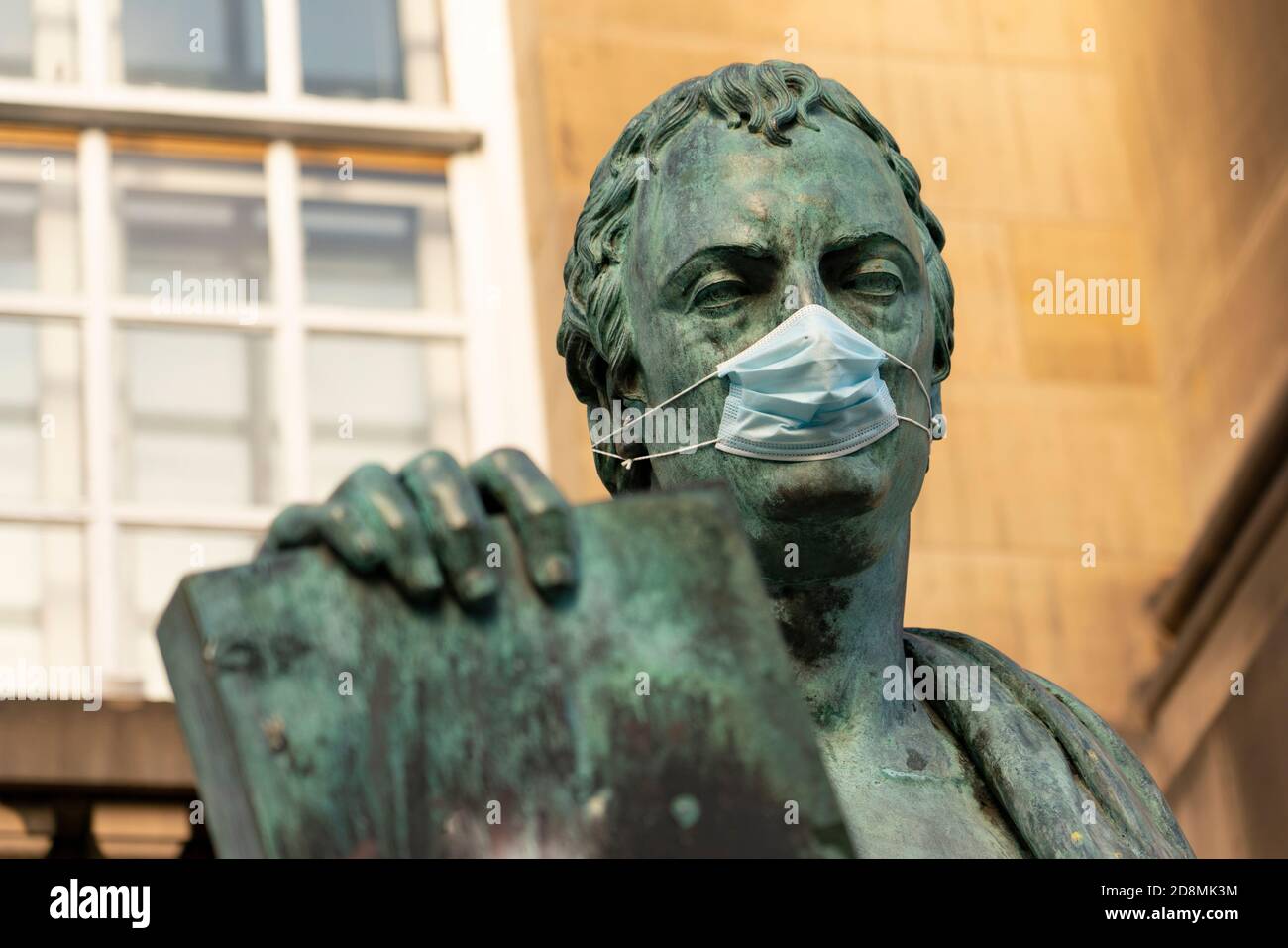 Statue of David Hume philosopher wearing facemask  on Royal Mile in Edinburgh, Scotland, UK Stock Photo