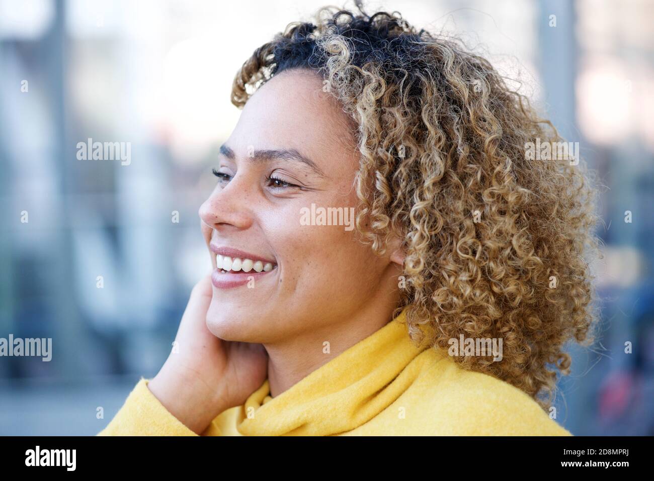 Close up side portrait of happy african american woman with curly hair ...