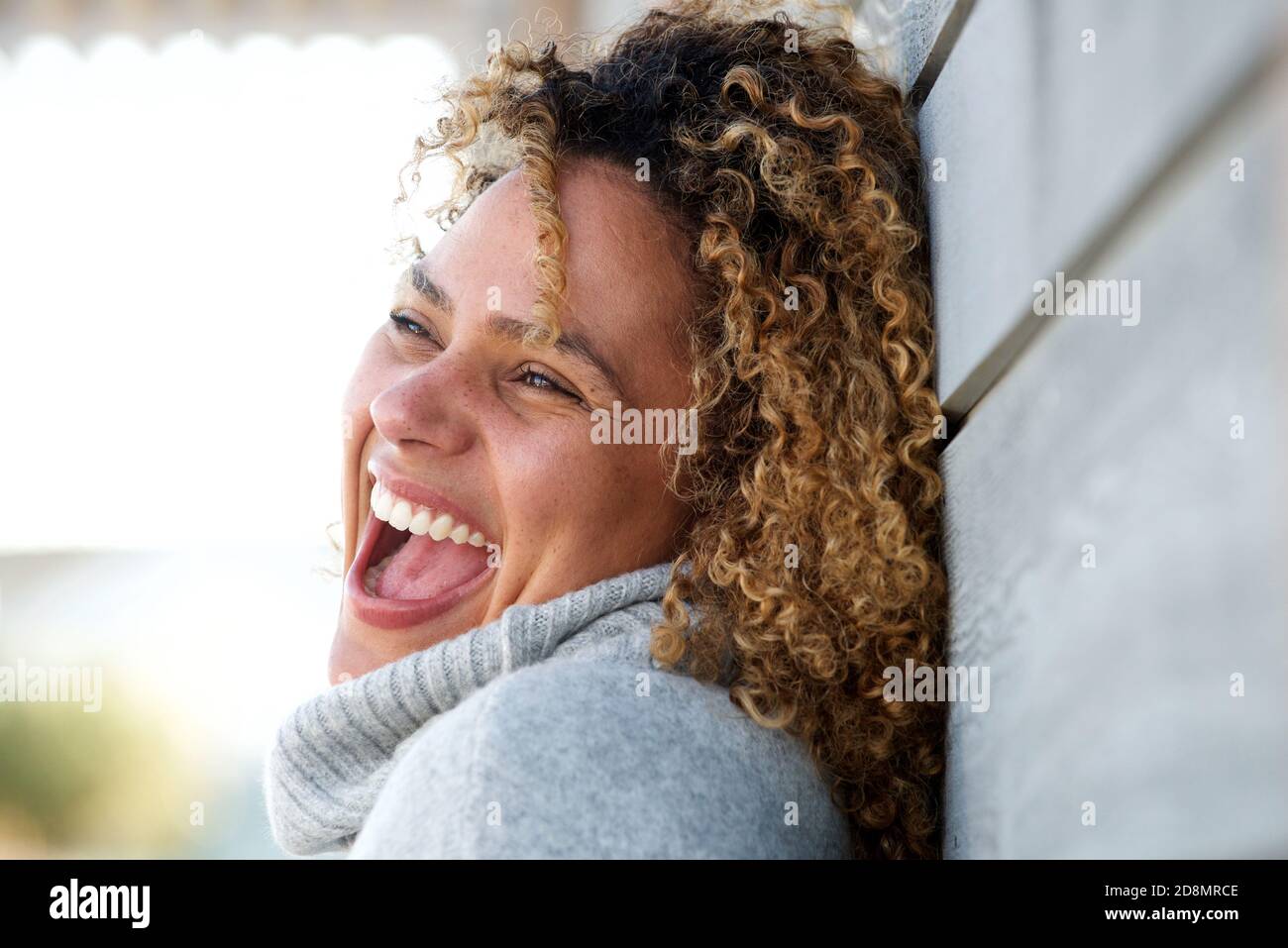 Close up side portrait of beautiful african american woman laughing ...