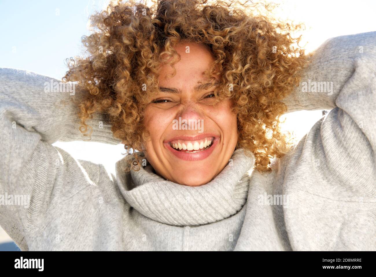 Close up portrait of happy african american woman laughing with hands ...