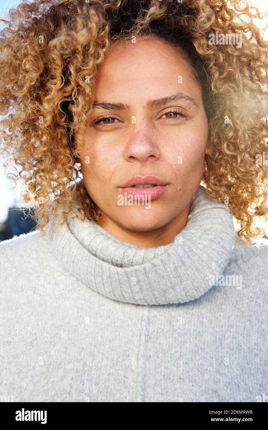 Close up portrait of beautiful young african american woman with curly ...
