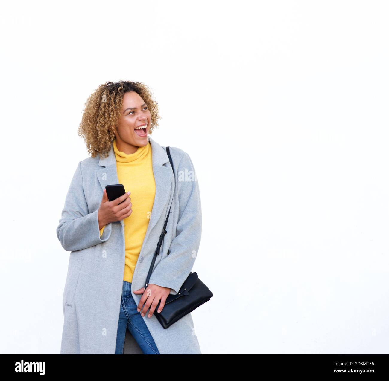 Portrait of happy young african american woman laughing against white ...
