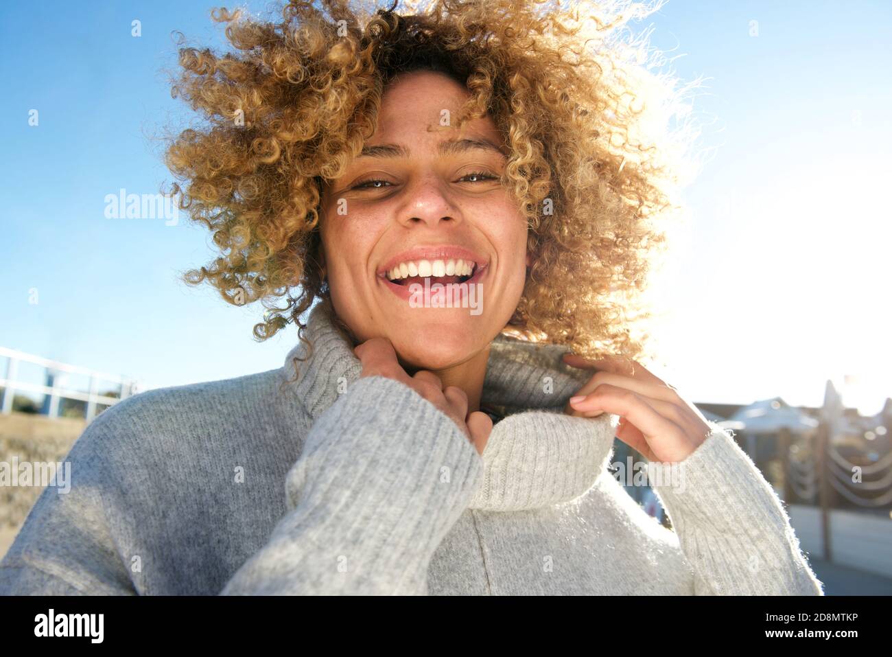 Close up portrait of cheerful african american woman with curly hair ...