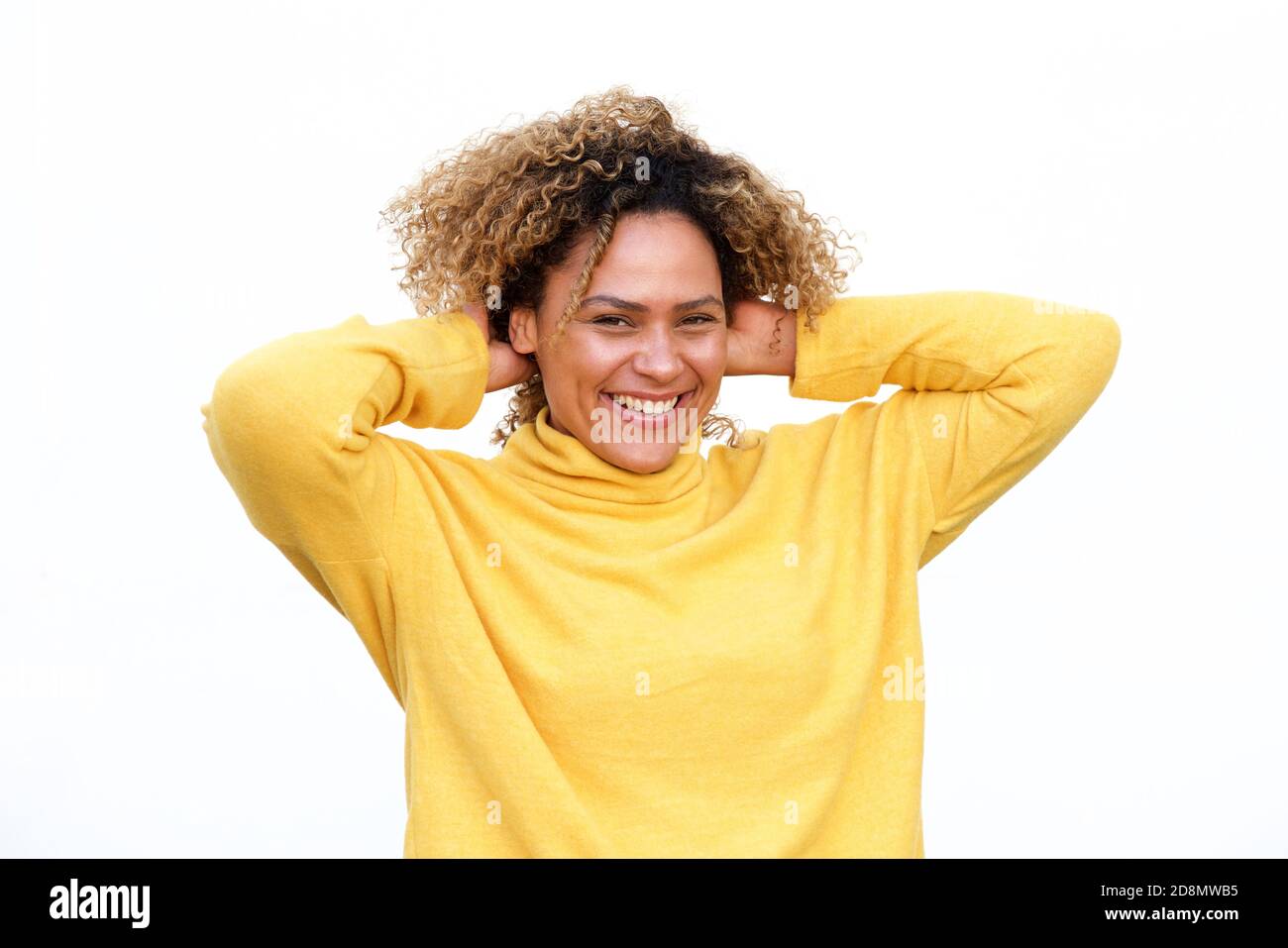 Portrait of happy young african american woman laughing against white ...