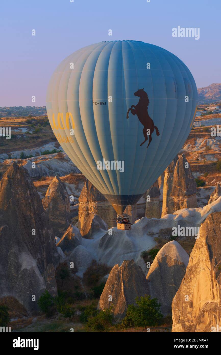 Hot air balloon in the morning among rocks in Cappadocia, Turkey Stock Photo