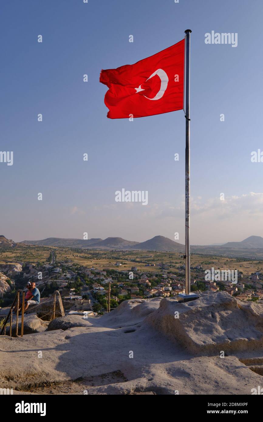 Big turkish flag on top of the ancient Uchisar castle in Cappadocia, Turkey Stock Photo