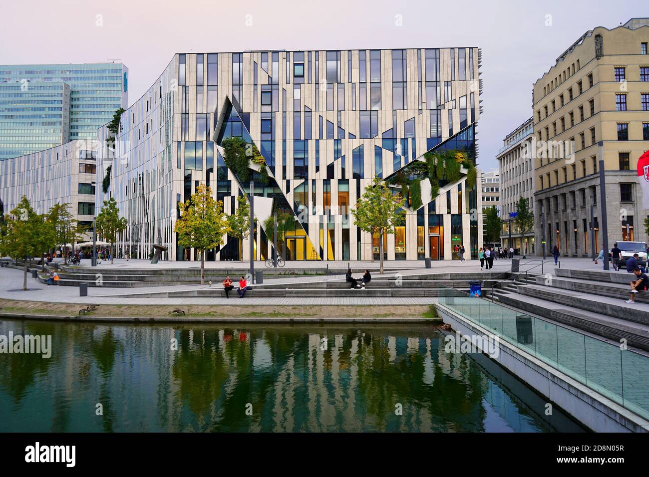The 'Kö-Bogen', a modern building complex designed by New York star architect Daniel Libeskind, completed in 2013. Warm late summer evening light. Stock Photo