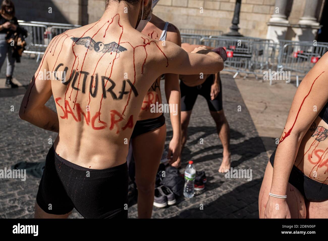 Actors from the Barcelona-based company Maravilla theater perform during ''Culture bleeds'' in Plaza de Sant Jaume.Due to the mandatory closure of theaters following the increase in Covid19 infections, the Maravilla theater company has staged a performance La cultura Sangra (culture bleeds) in Plaza Sant Jaume to denounce the precarious economic state suffered by small theater companies. Stock Photo