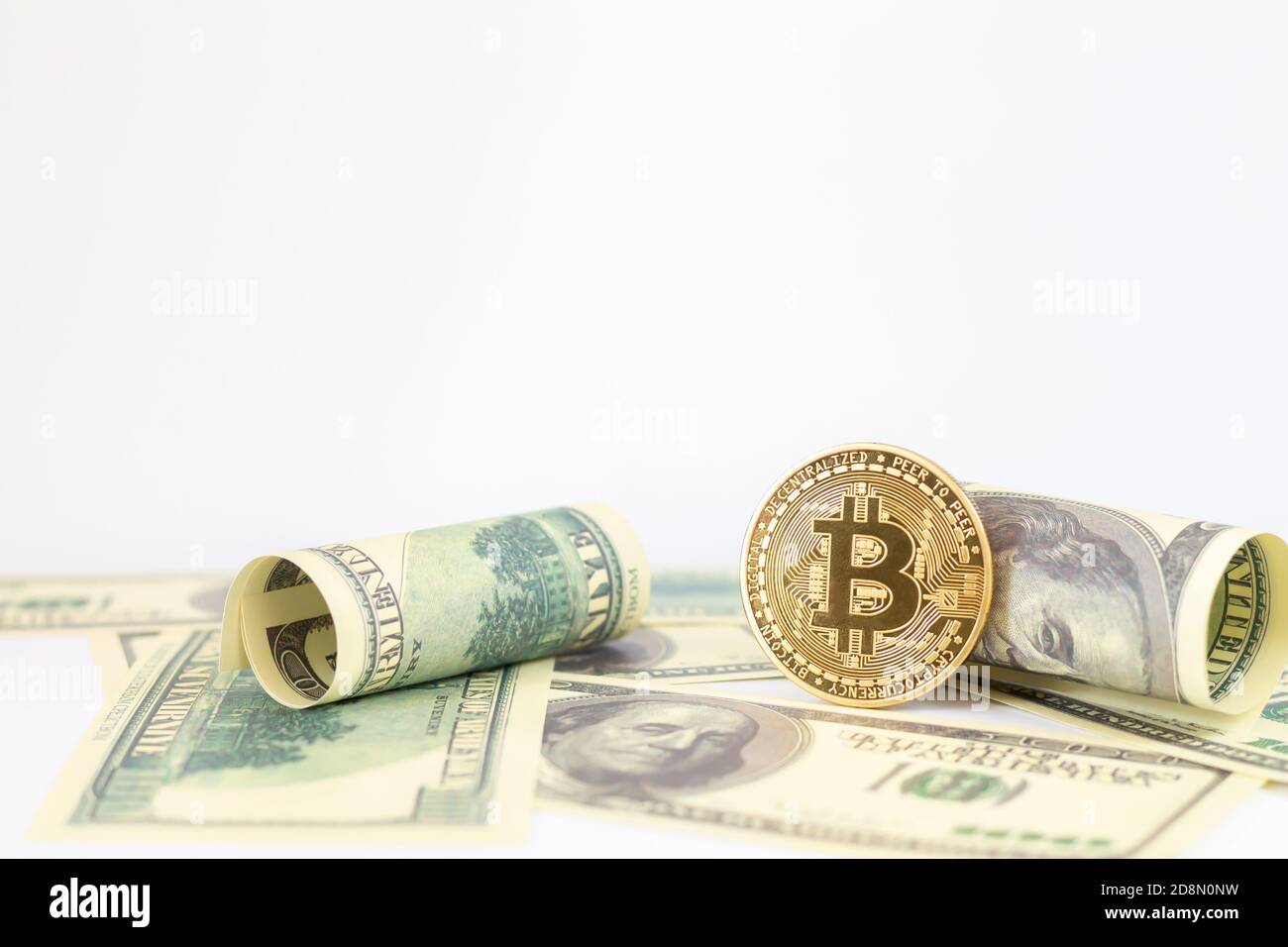 Gold bitcoin and US dollar banknotes isolated on white background Stock Photo