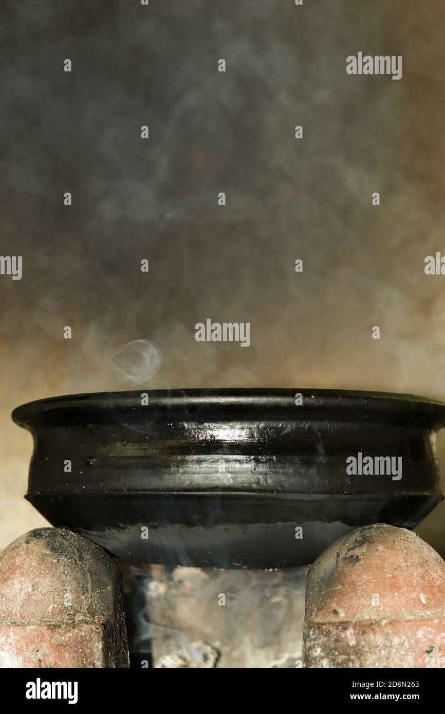 Traditional way of making food in Rural Kitchen on open fire in Kerala