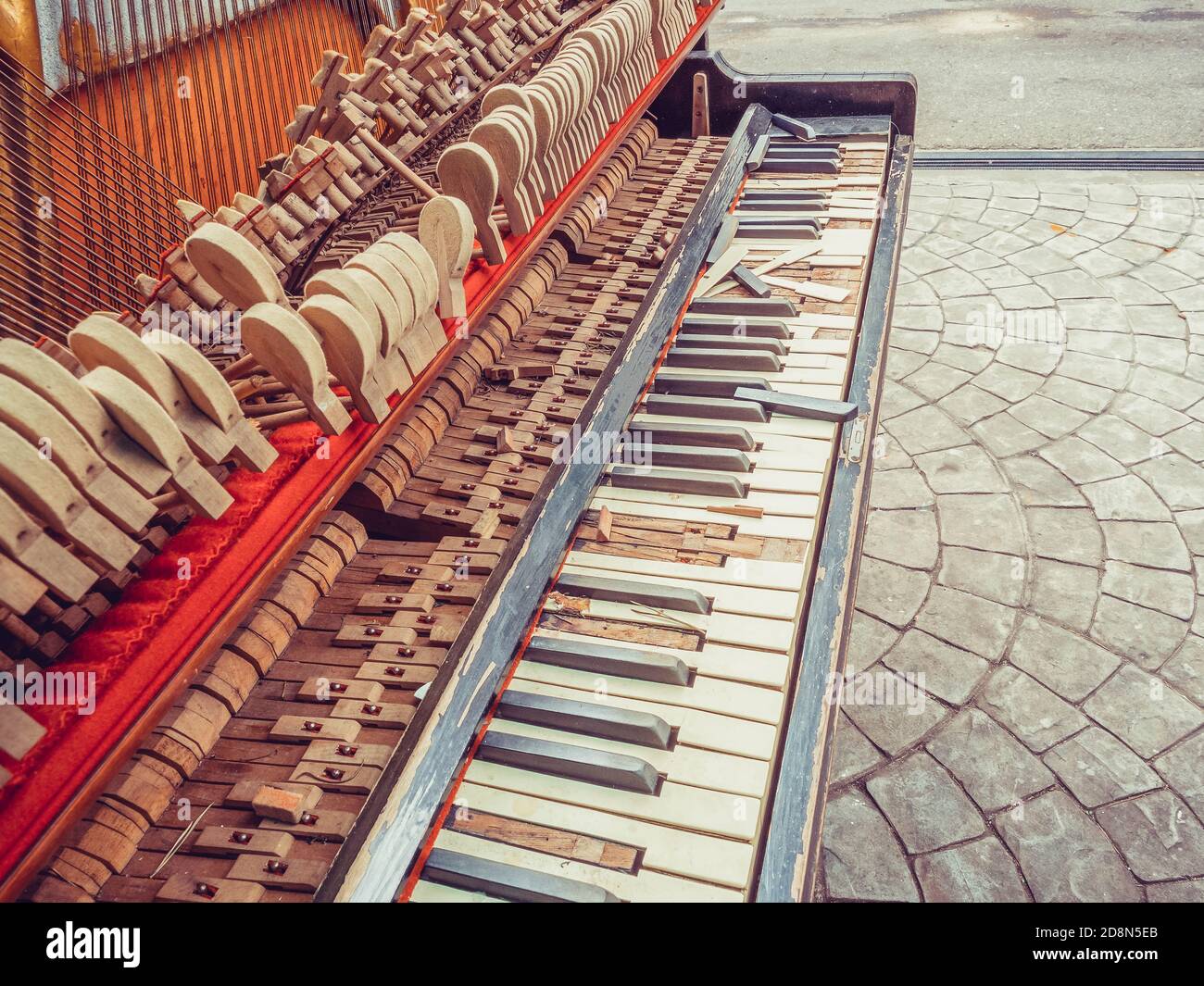 A fragment of an old broken piano with a missing wall and broken keys