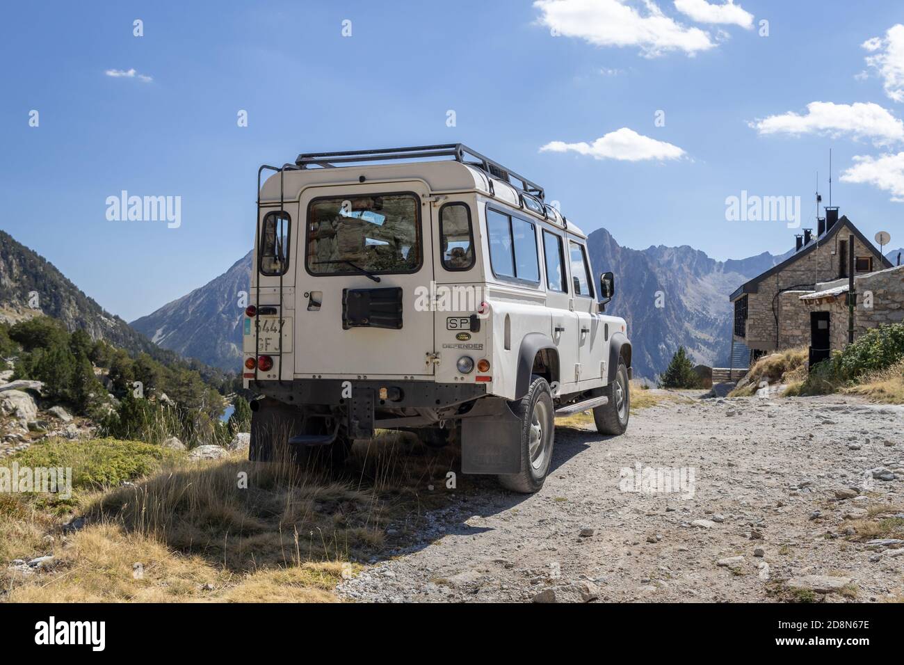 ESPOT, SPAIN-SEPTEMBER 5, 2020: Land Rover Defender 110 Station wagon standing on a mountain road (rear view) near the mountain cabin Stock Photo