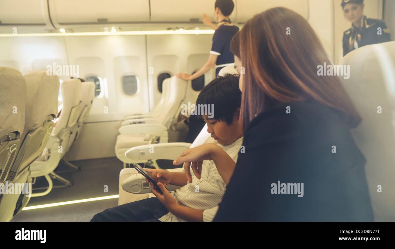 Cabin crew provide service to family in airplane . Airline
