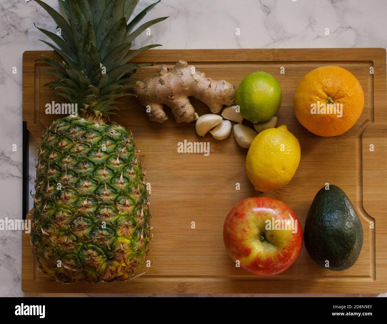 Healthy food and ingredients on bamboo cutting board Stock Photo