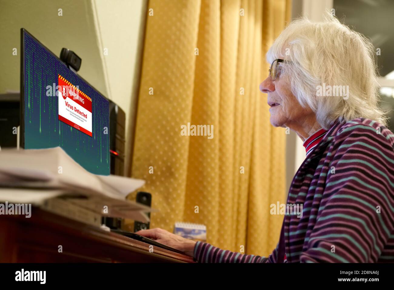 Old elderly senior person with virus warning on computer monitor screen