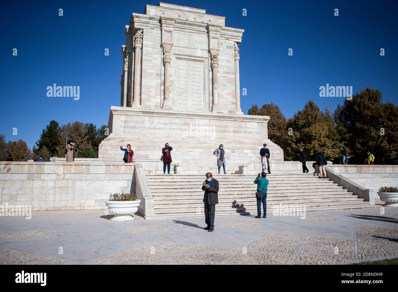 Tehran, Iran. 30th Oct, 2020. People wearing face masks visit the tomb of Persian poet Ferdowsi in ancient city of Tous, Iran, Oct. 30, 2020. Ferdowsi was a Persian poet and the author of Shahnameh, which is one of the world's longest epic poems created by a single poet. Credit: Ahmad Halabisaz/Xinhua/Alamy Live News Stock Photo