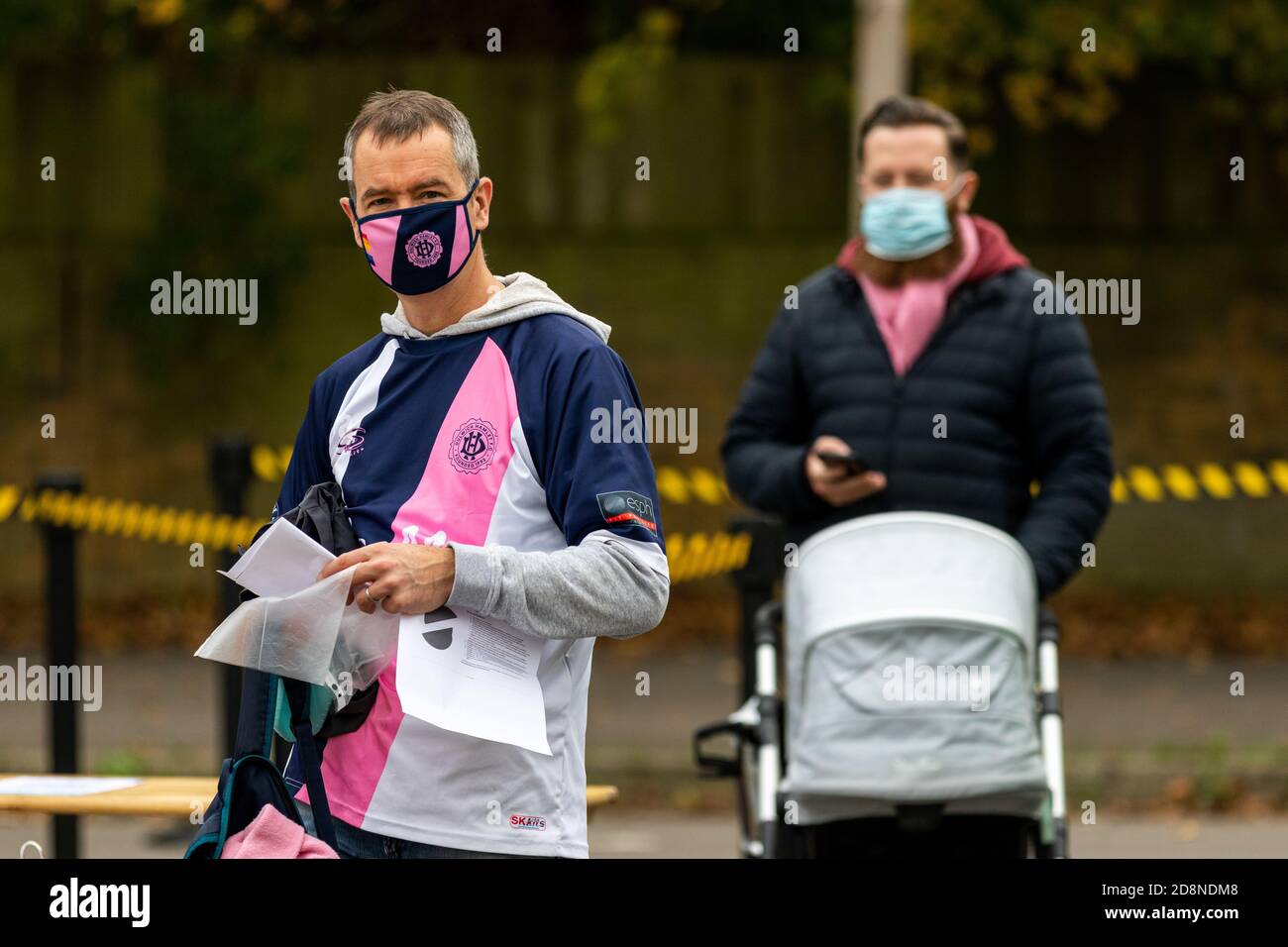 Dulwich Hamlet supporters wearing face masks as they enter Champion Hill Stadium for a Women's Football match. Stock Photo