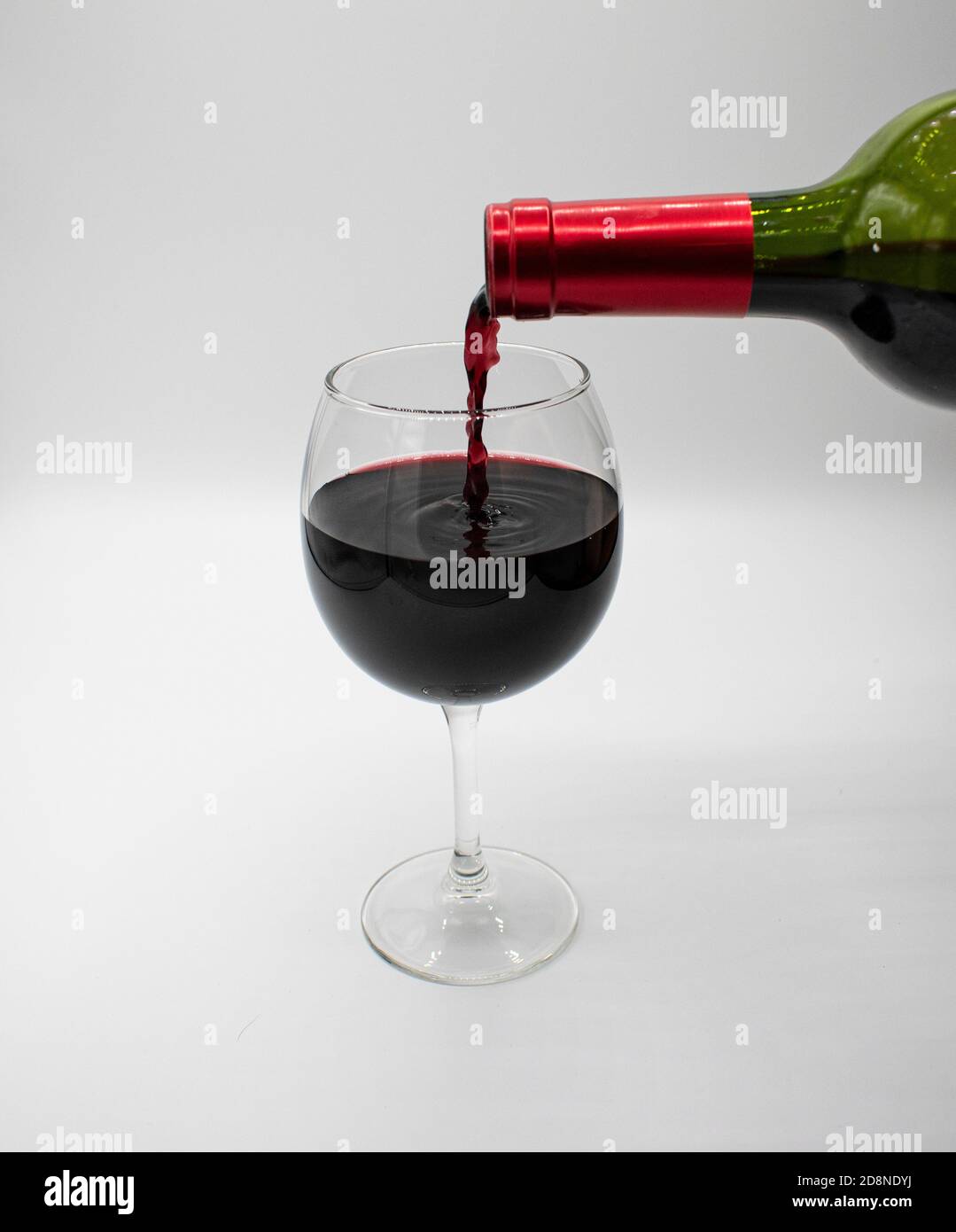 https://c8.alamy.com/comp/2D8NDYJ/close-up-of-wine-glass-with-red-wine-from-the-bottle-going-into-the-glass-2D8NDYJ.jpg