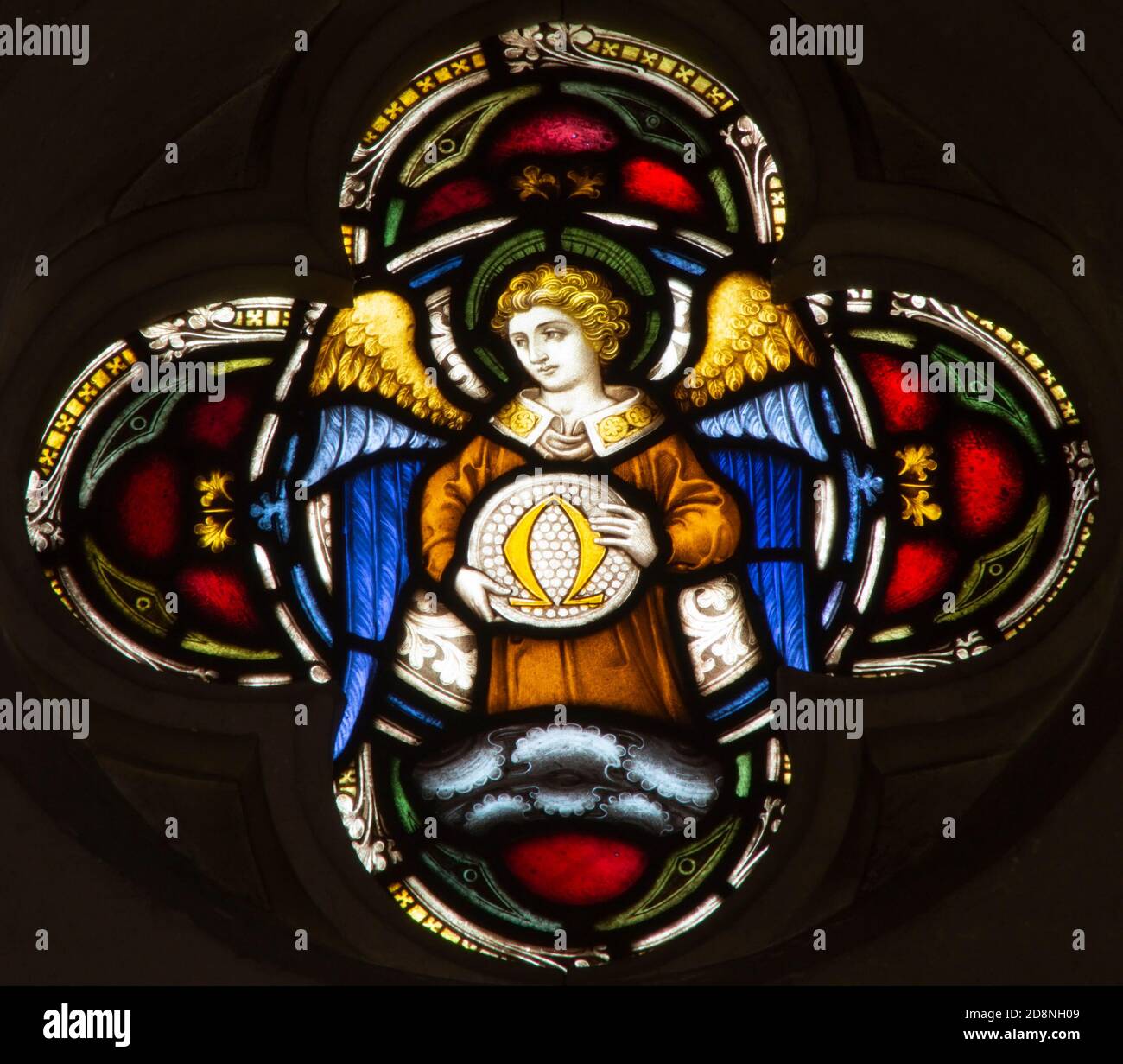 ROME, ITALY - MARCH 9. 2016: The angel with the symbolic Omega symbol on the stained glass rosette of All Saints' Anglican Church Stock Photo