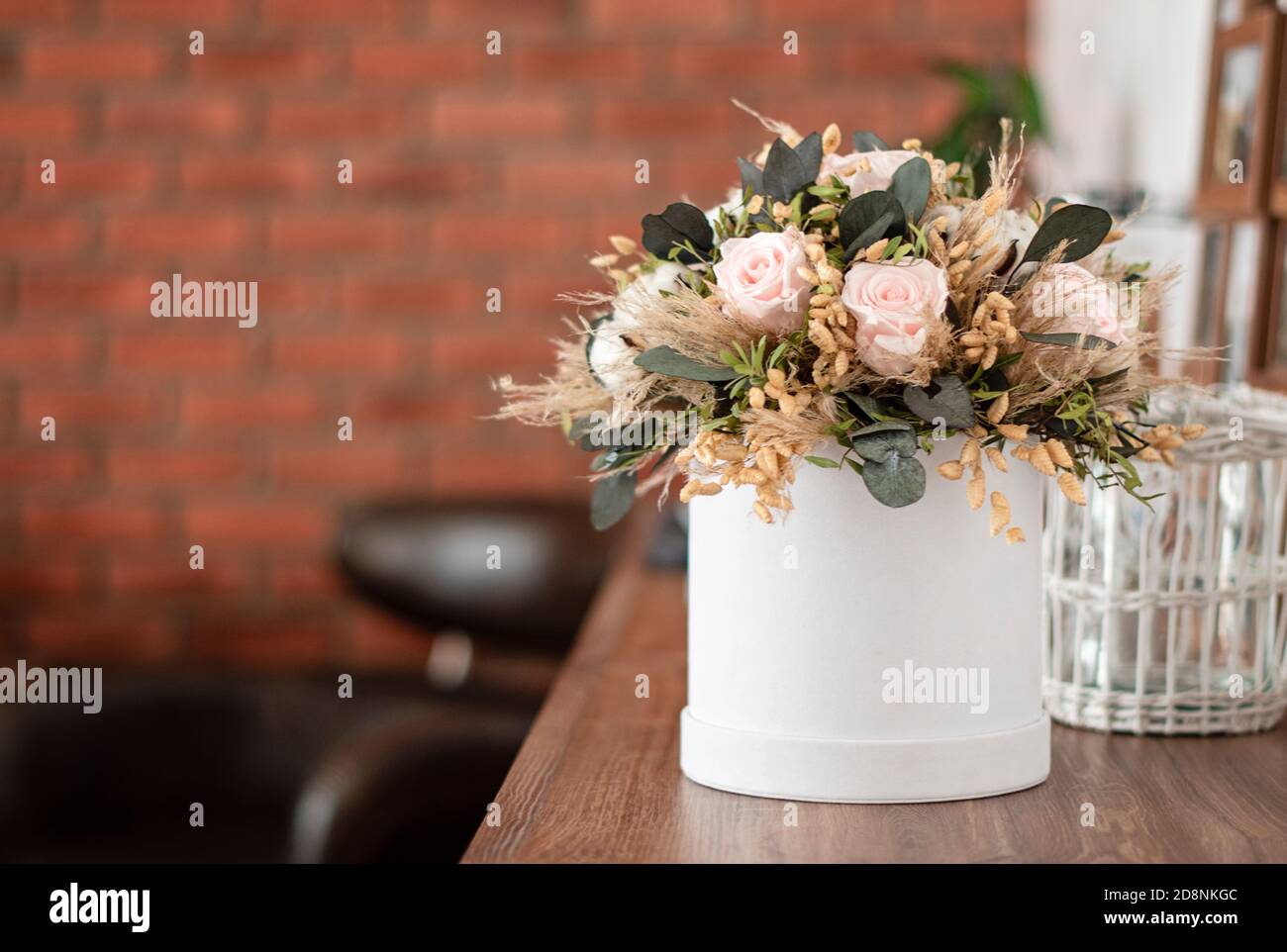 Long lasting flowers decoration. Preserved roses bouquet closeup. Selective focus on home decoration made of decorative plants. Eternal, stabilized, f Stock Photo