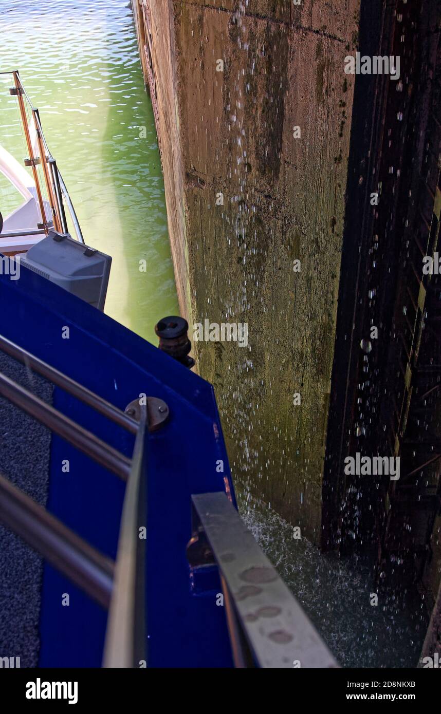 Bollene Lock, door open, riverboat exiting,tight fit, close to wall, Rhone River, 71 foot water level difference, navigable, waterway technology, mari Stock Photo