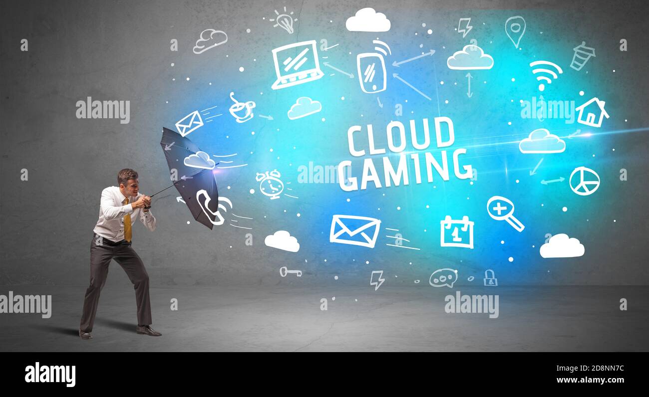 Businessman defending with umbrella from CLOUD GAMING inscription, modern technology concept Stock Photo
