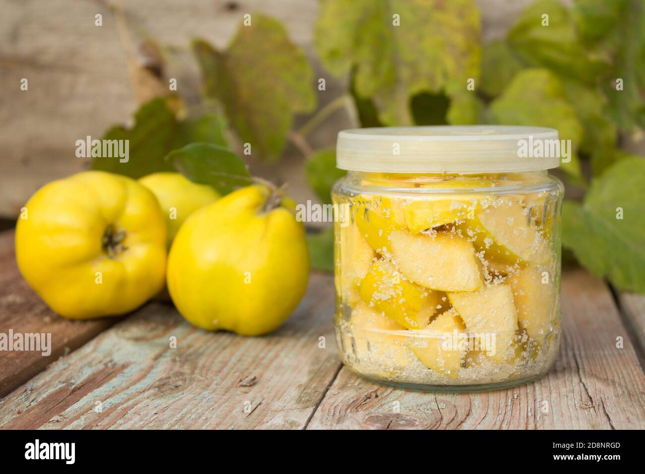 Quince, glass jar with candied quince on wooden background Stock Photo