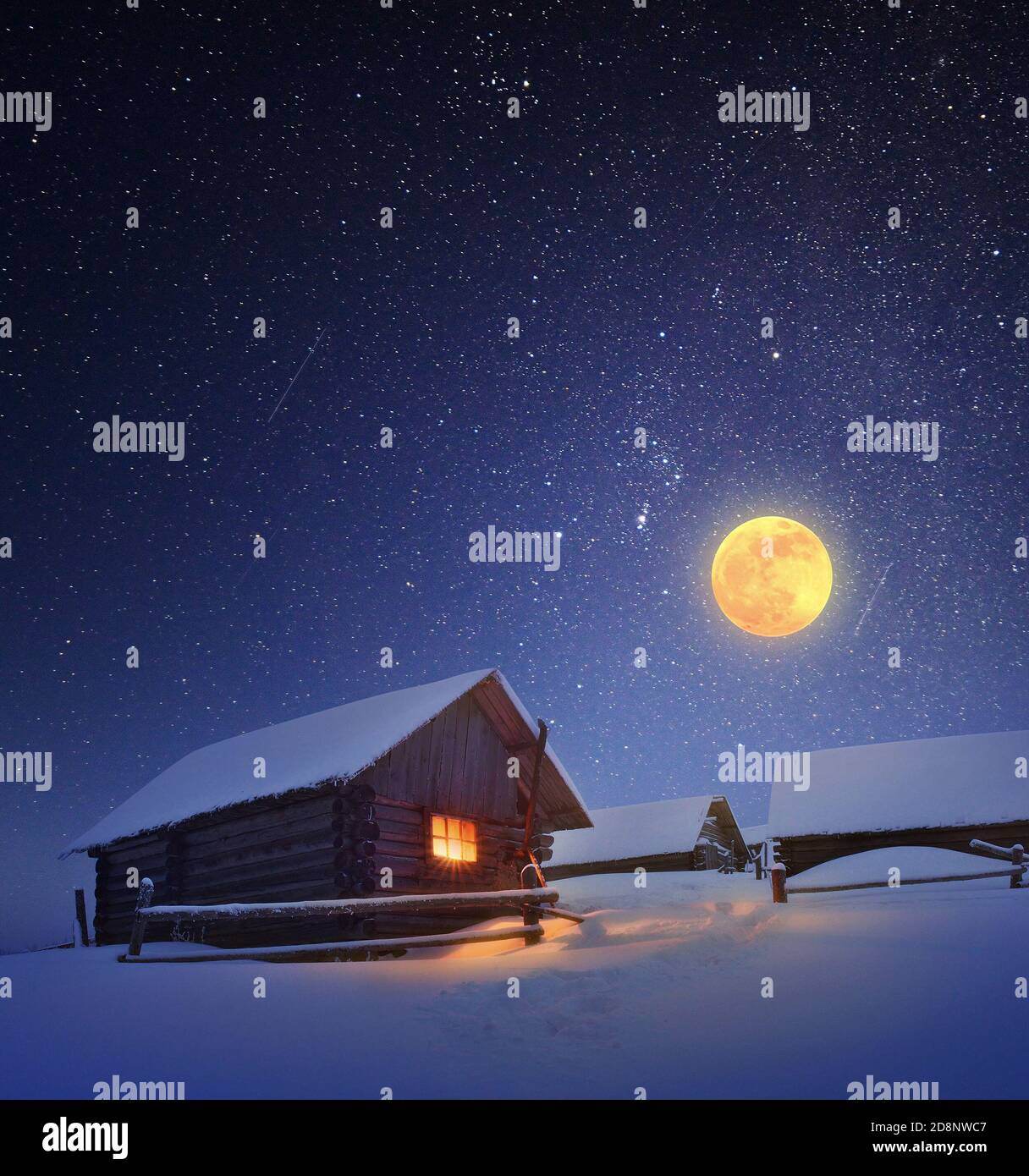 Winter landscape with a starry sky and the full moon. The light in the ...