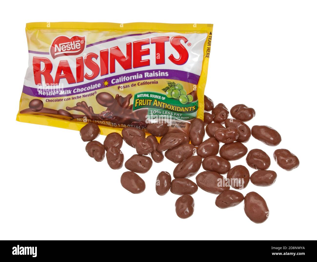Scattered Raisinets on a white background with the packaging Stock