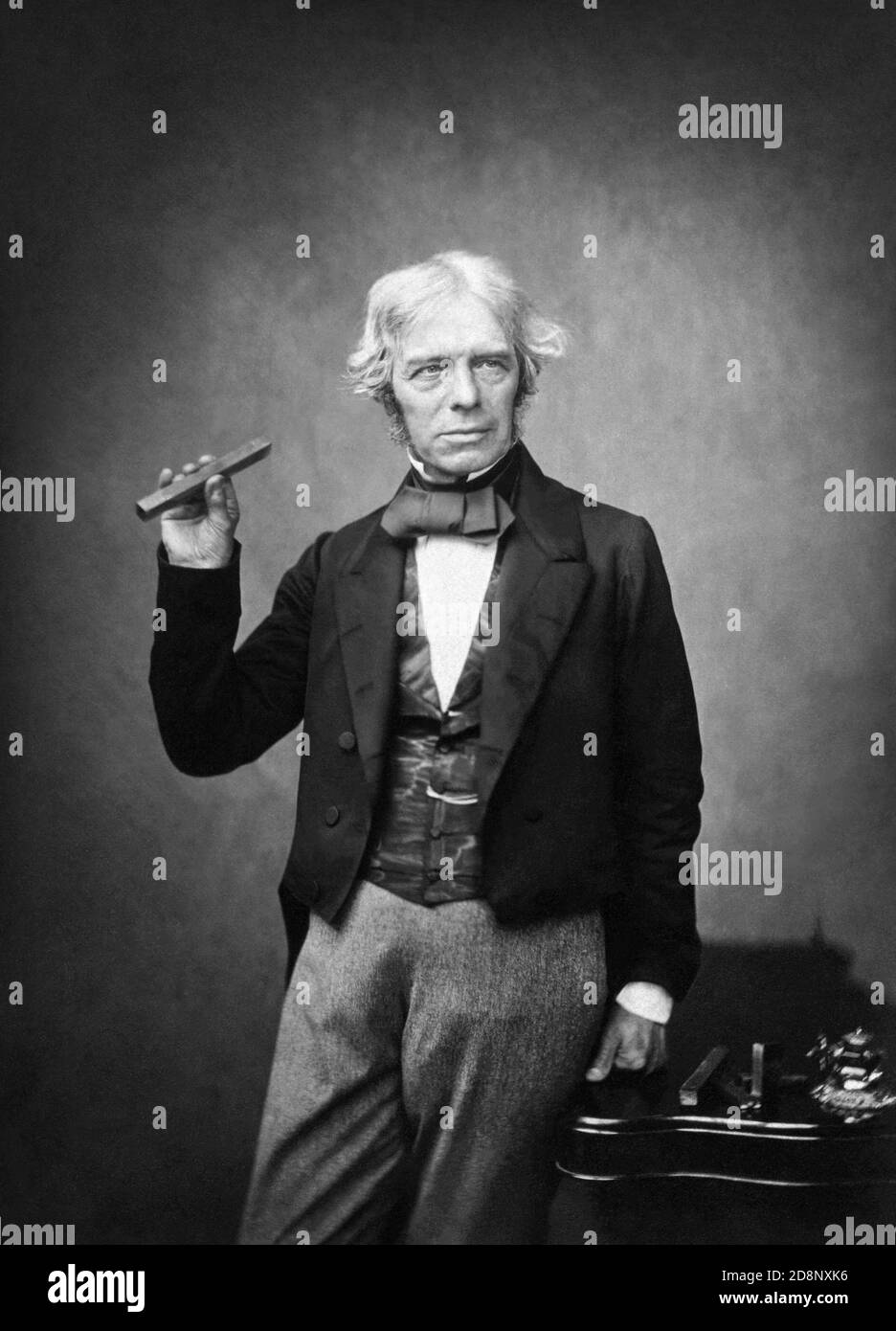 Michael Faraday FRS (1791–1867), one of the most influential scientists in history, holding a bar magnet in 1857 in a portrait by Maull & Polyblank. Stock Photo
