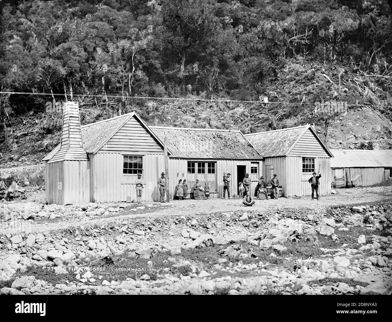 The Otira Gorge accommodation house was built in 1865 on the banks of the Otira River on the West Coast of New Zealand to meet the needs of gold prospectors going to the West Coast. It was washed away in a flood in 1886. Photo by the Burton Brothers. Stock Photo