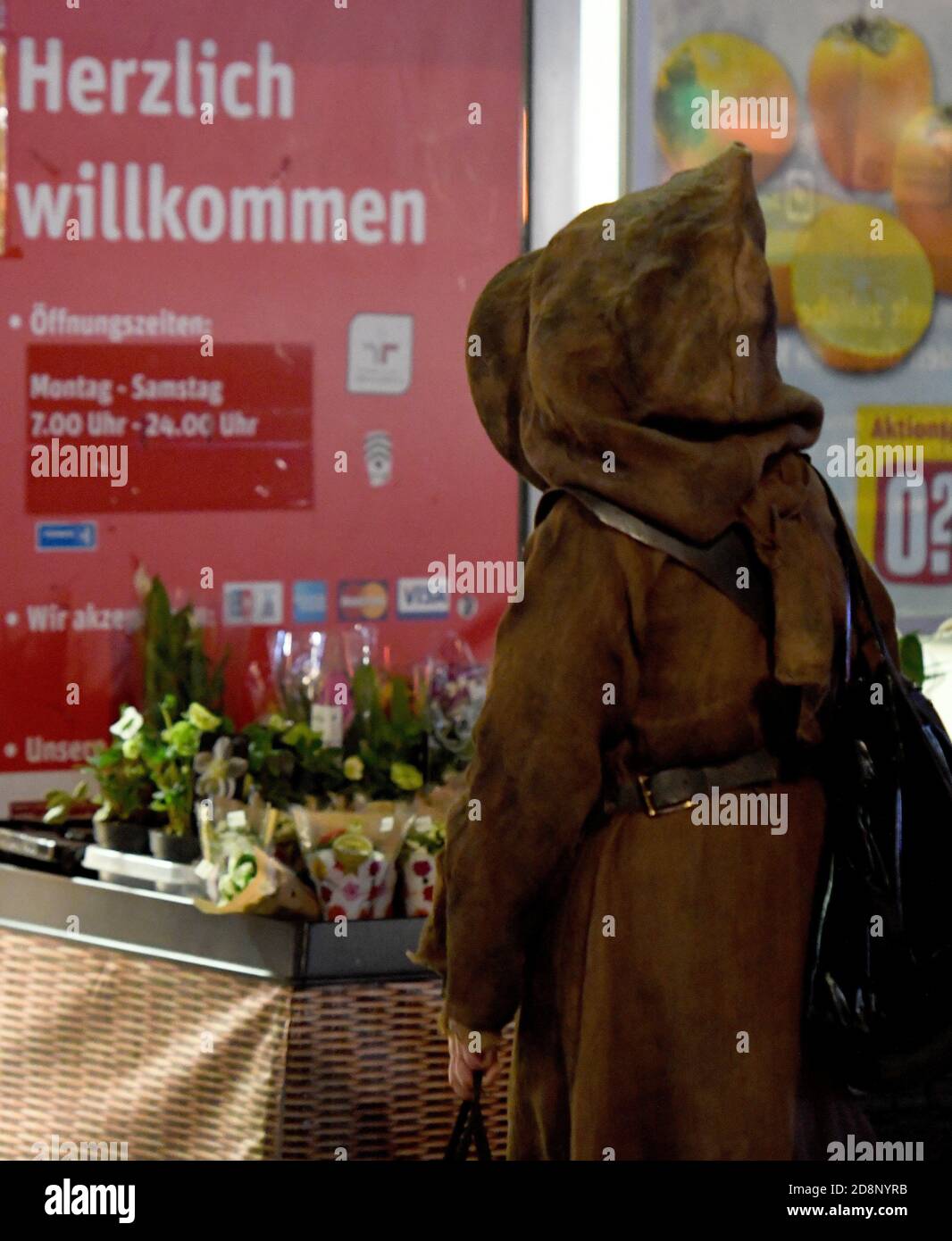 Bochum, Germany. 31st Oct, 2020. An Ewok, a character from the Star Wars stories, dressed up for Halloween, is standing in a queue in front of the supermarket. Credit: Caroline Seidel/dpa/Alamy Live News Stock Photo