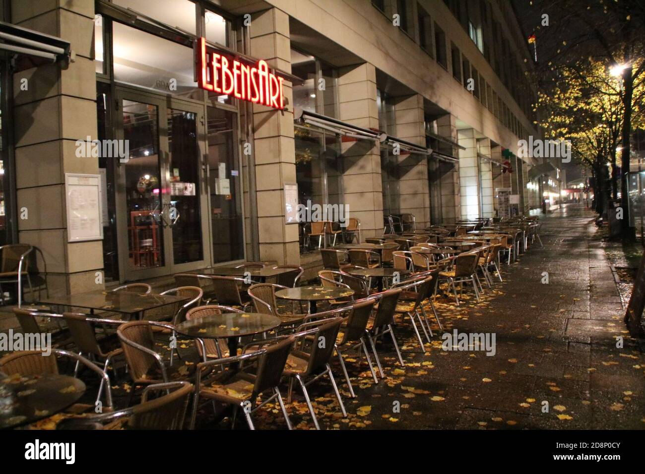 Berlin, Germany. 30th Oct, 2020. Empty sidewalk in front of the Cafe LebensArt near the Brandenburg Gate after 11 pm. To contain the corona pandemic, public life in Berlin will be partially shut down for four weeks starting November 2. Credit: Cevin Dettlaff/dpa/Alamy Live News Stock Photo
