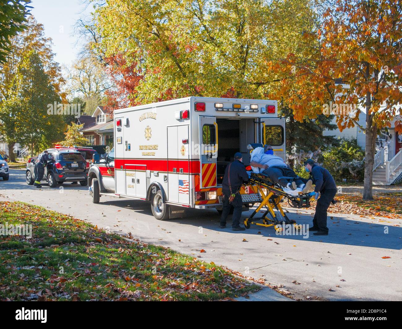 Oak Park, Illinois, USA. 31st October 2020. Paramedics load an automobile accident victim into