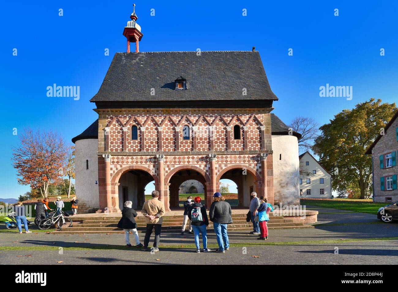 Lorsch, Germany, Abbey of Lorsch with guided tour with small group of people keeping distance and wearing face masks due to Corona virus restrictions Stock Photo