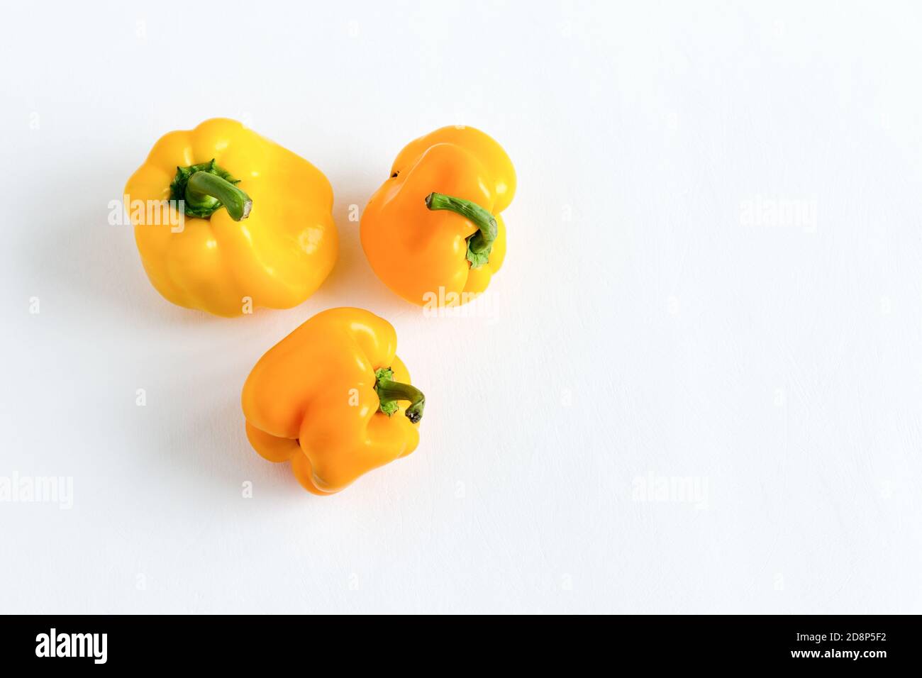 Deformed bell peppers isolated on a white background. Organic vegetables with an ugly shape. Imperfect vegetable or food waste concept. Flat lay with Stock Photo