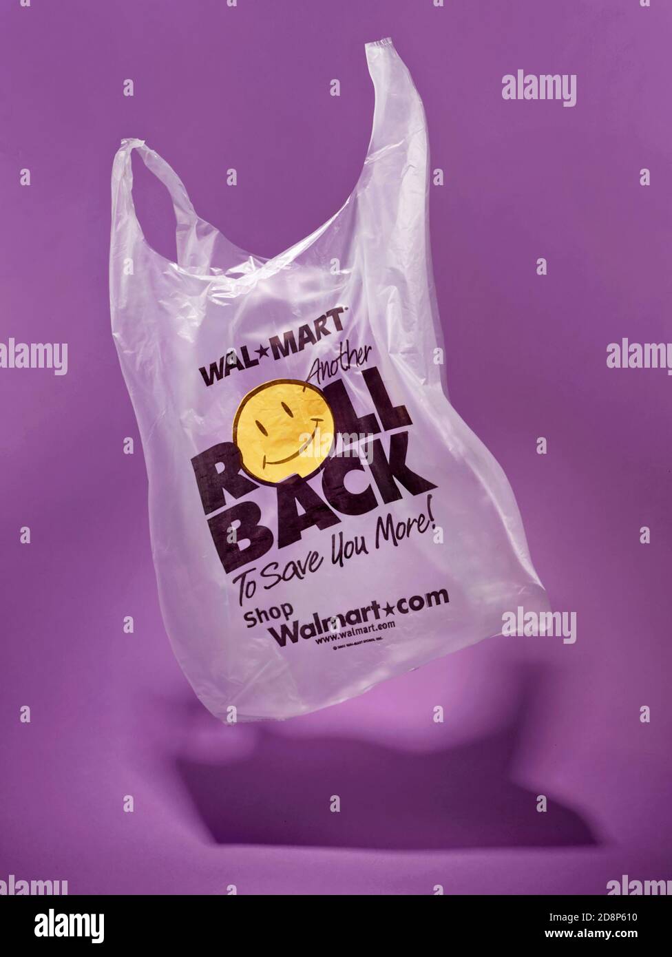 Roll back Walmart grocery bag floating photographed on a purple background Stock Photo