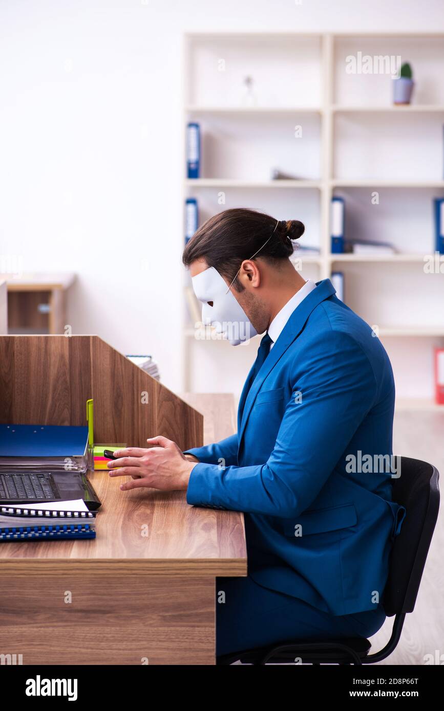 Young employee wearing mask in the office Stock Photo - Alamy