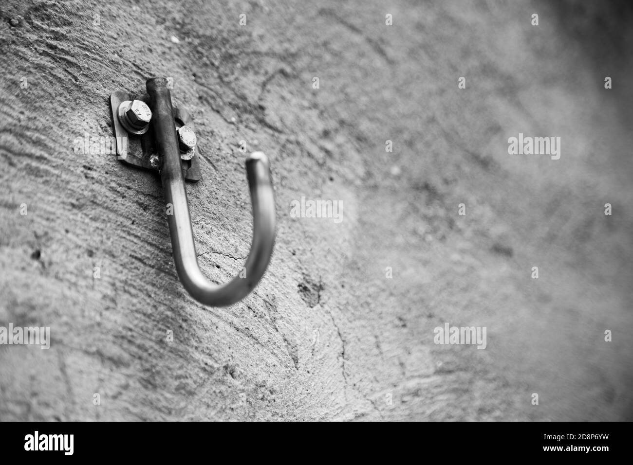 Grayscale shot of a hook attached to a concrete wall Stock Photo Alamy