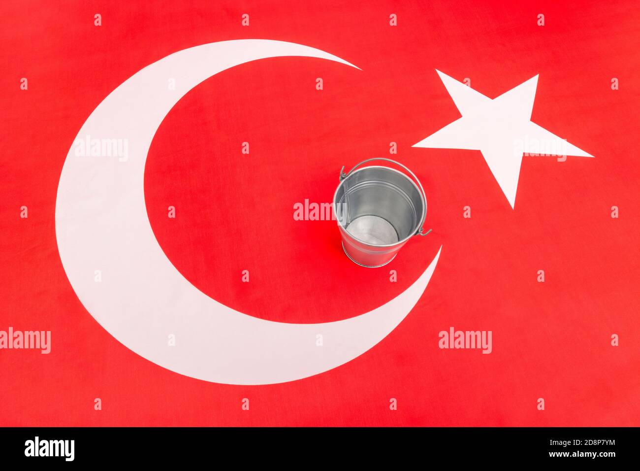 Turkish flag with an empty metal bucket. For Turkey's financial crisis