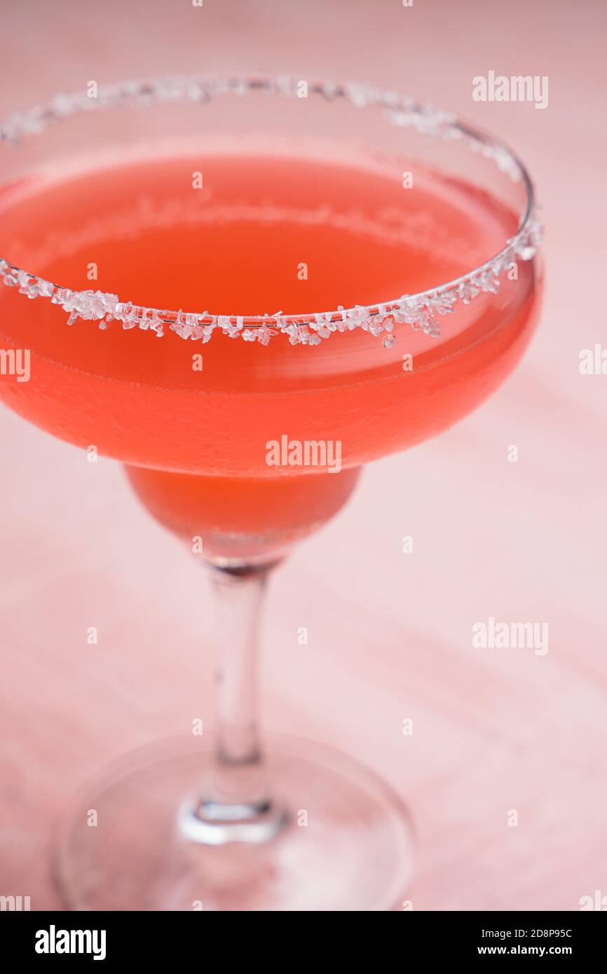 Red Margarita cocktail on a pink background Stock Photo