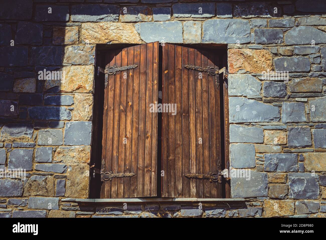 Wooden window closed on a brick wall. wooden shutters. History concept Stock Photo