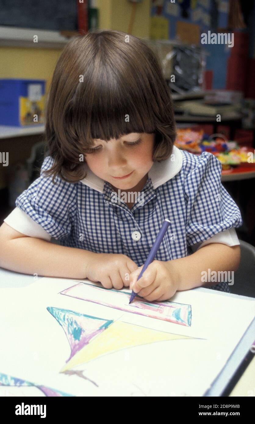 little girl in primary school classroom colouring Stock Photo