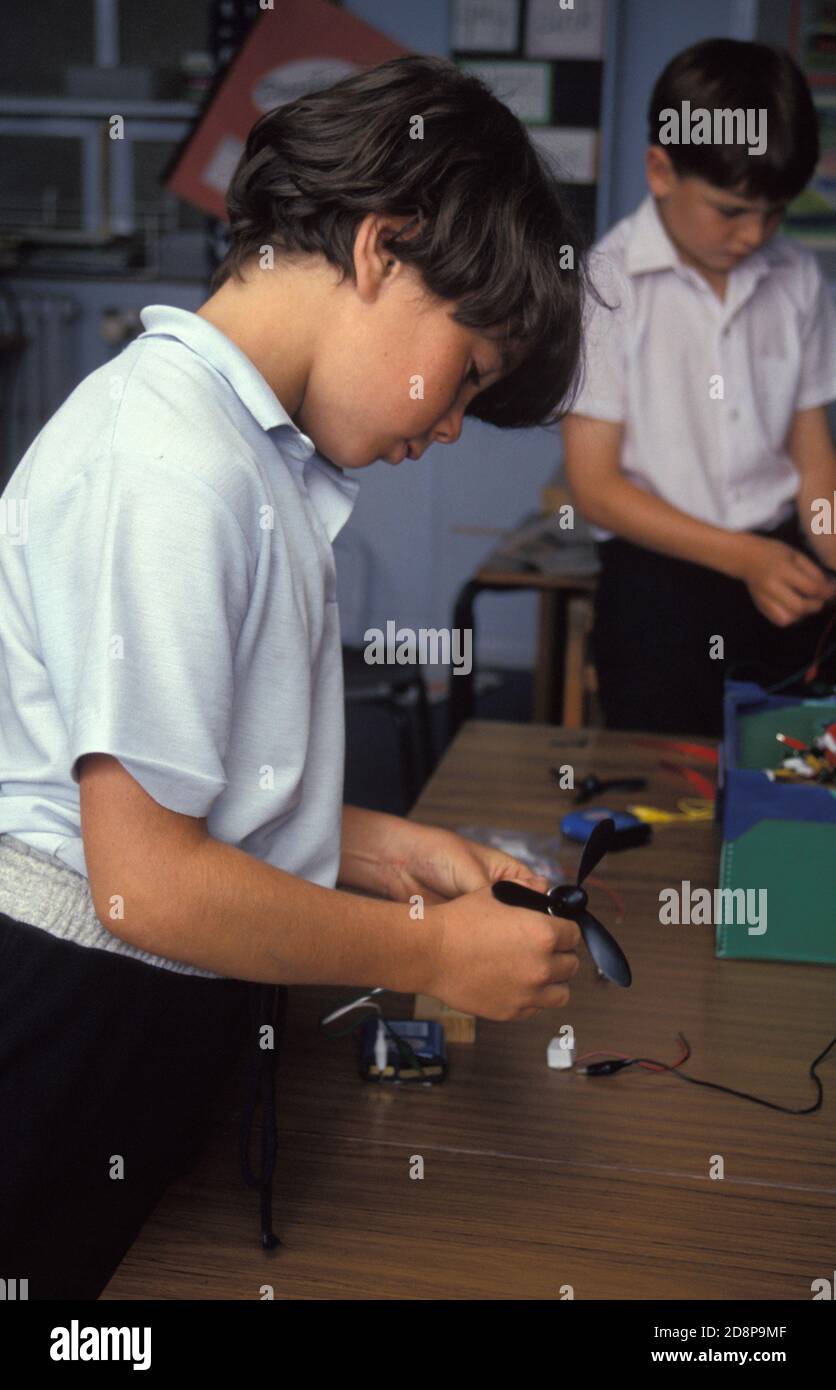juvenile boys in technology class experimenting with electronics Stock Photo