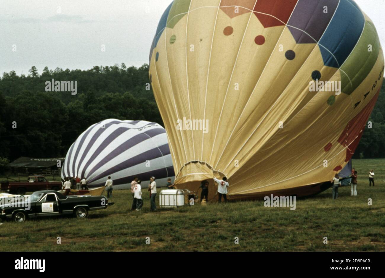 Hot air balloons being inflated with propane burners outside of Helen; Georgia; near Robertstown for the second annual Helen to Atlantic Ocean balloon race. The competition began outside of town in an area being developed by a corporation as a second alpine village. Helen was a typical small mountain community until 1969 when town officials; businessmen and residents endorsed renovation of the business district with a bavarian alpine motif Stock Photo